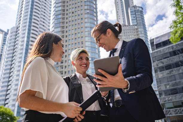 istock Successful business people discussing ideas on a digital tablet 1198814688