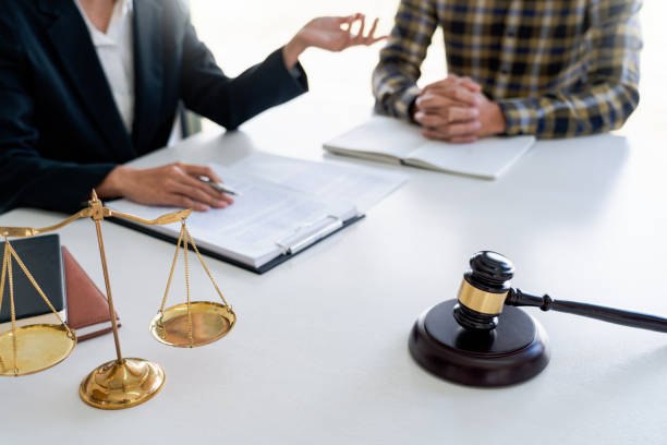 istock Midsection Of Lawyer And Client Discussing While Sitting On Table 1198814913