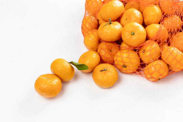 istock Fresh citrus tangerines in a grid on a white background close-up. 1198817336