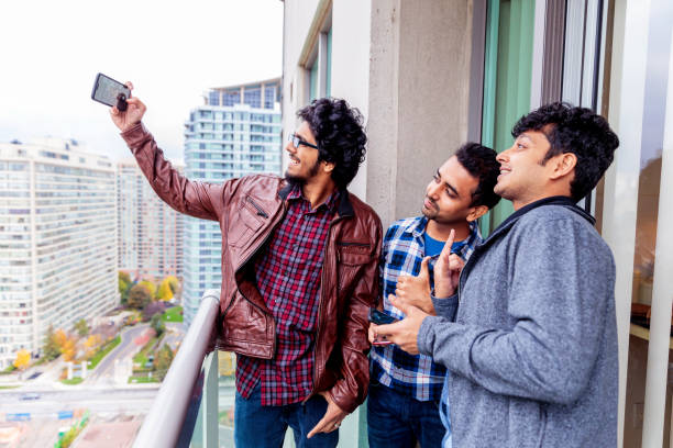 istock Friends taking a selfie using a smartphone in the balcony 1198818037