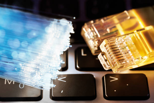 istock Network cable and fiber optic on laptop computer 1198819784