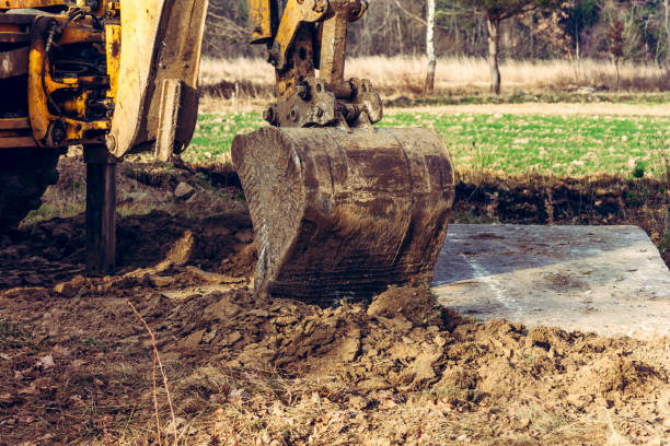 istock The bucket excavator pulls up concrete slabs to set the road. 1198820043