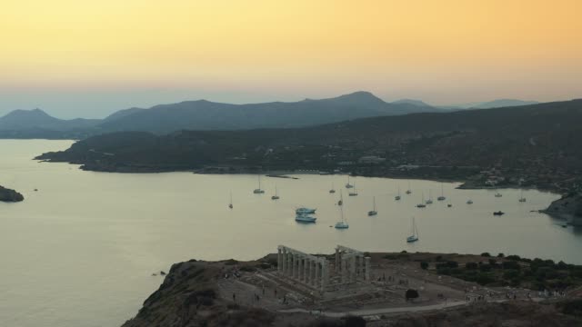 Aerial Shot of cape Sounio in Athens,Athens, Greece with the ancient Temple of Poseidon during the sunset at summer