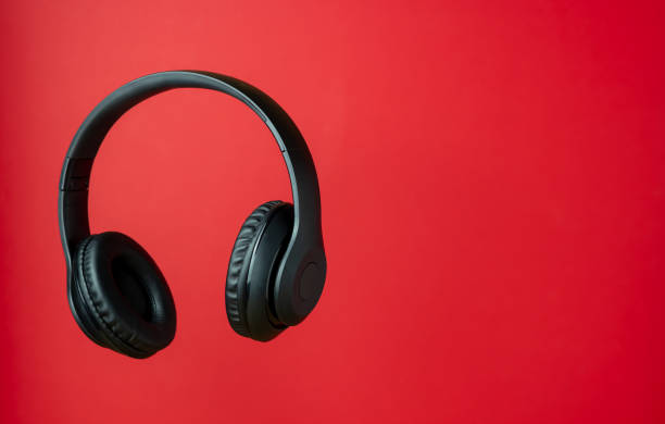istock Black headphones on a red background. Minimal concept. 1198824113