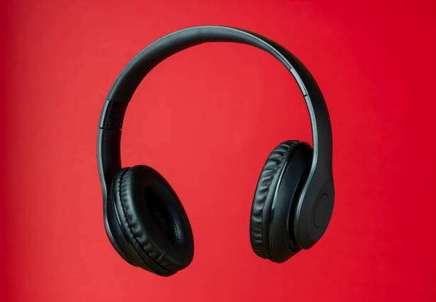 istock Black headphones on a red background. Minimal concept. 1198824118