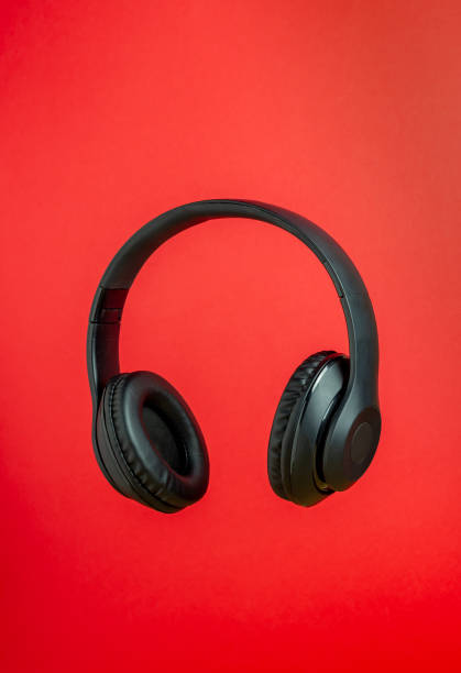 istock Black headphones on a red background. Minimal concept. 1198824129