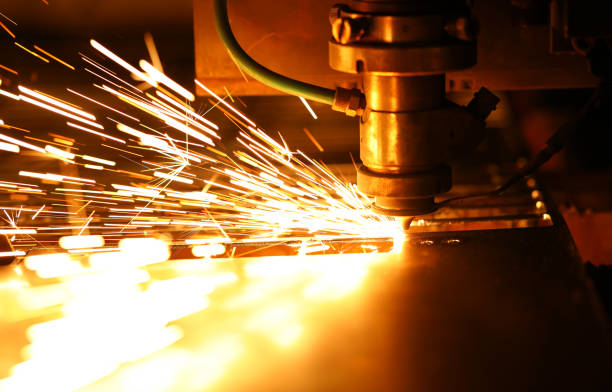 istock Bright blaze and sparkles while automated laser device cutting steel 1198827801
