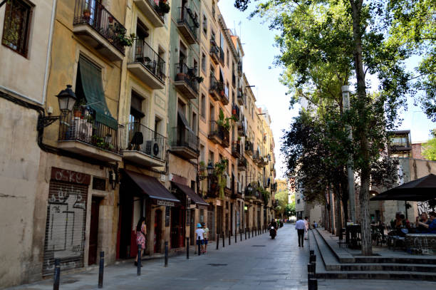 BARCELONA / SPAIN - August 2018: Winding streets of Barcelona. Small buildings and shops are built closely together creating a maze network of alleys and streets to get lost in.