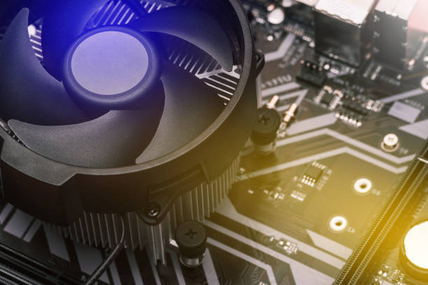 istock Computer motherboard. The cooling system of the processor on the computer. Cooler with a fan on the motherboard. Electronic circuit board close up 1198829914