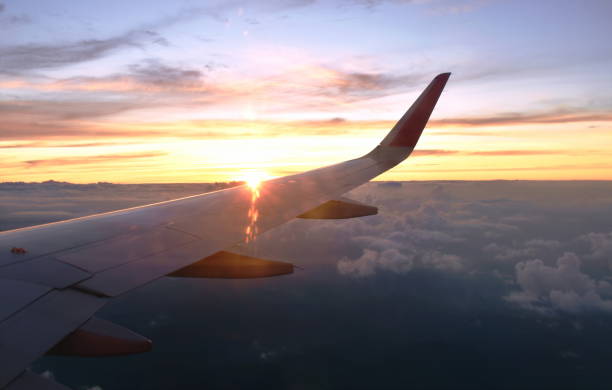 istock plane wing and cloud floating on the sky on sunset 1198831249