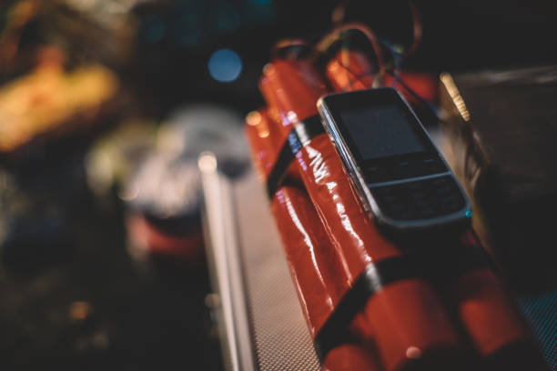 Dynamite bomb with mobile phone attached to it Dynamite bomb with mobile phone attached to it in workshop, no people. bomb stock pictures, royalty-free photos & images