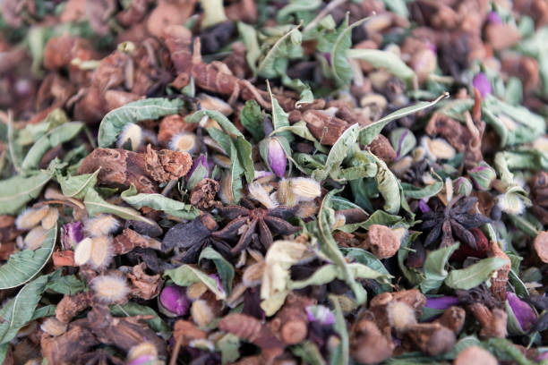 Traditional moroccan tea mixture with dried herbs, spices and rose buds. stock photo
