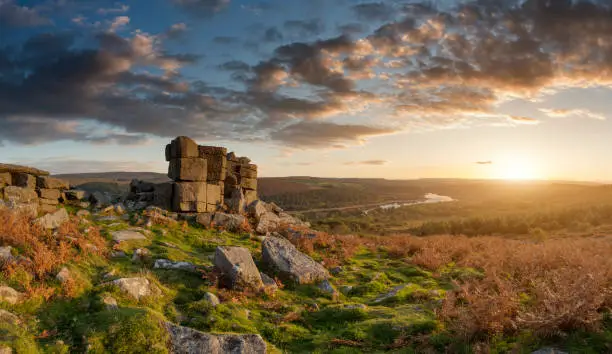 Epic sunset over landscape of Leather Tor in Dartmoor during Summer with dramatic sky