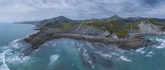 Zumaia and Deba flysch geological strata layers drone aerial view panorama, Basque Country