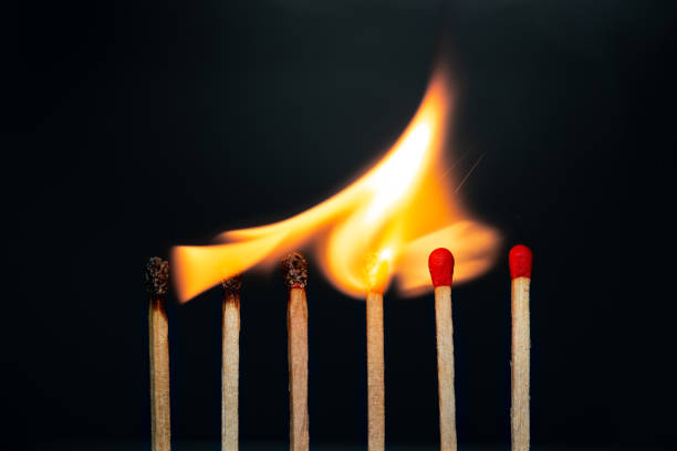 istock Group match burning on a black background detail art 1198837286