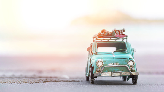 Miniature  tin car  closeup at summer beach scene