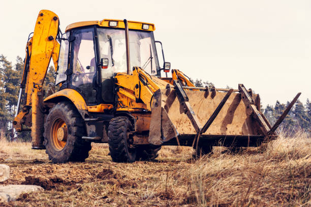 istock A yellow excavator works on the forest clearing and digs soil. 1198839945