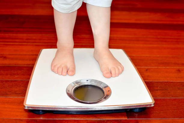 istock child's feet on an electronic scale 1198841537