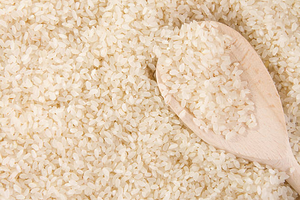 istock rice background and wood spoon 119884155