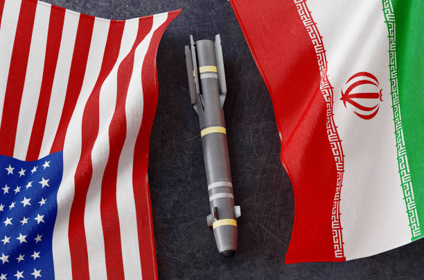 istock Iran flag and USA flag. Nuclear atomic risk. War concept. 3d rendering 1198841888