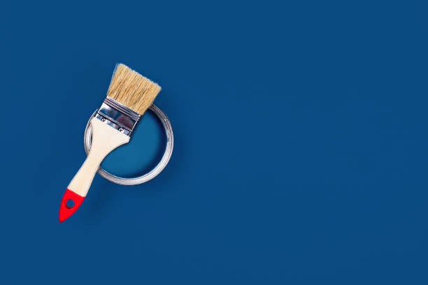 istock Blue background with paint jar and brush. 1198842500