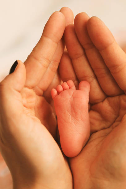 istock Hand the sleeping baby with mother hand 1198844191