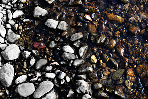 Pebbles in riverside, texture background.