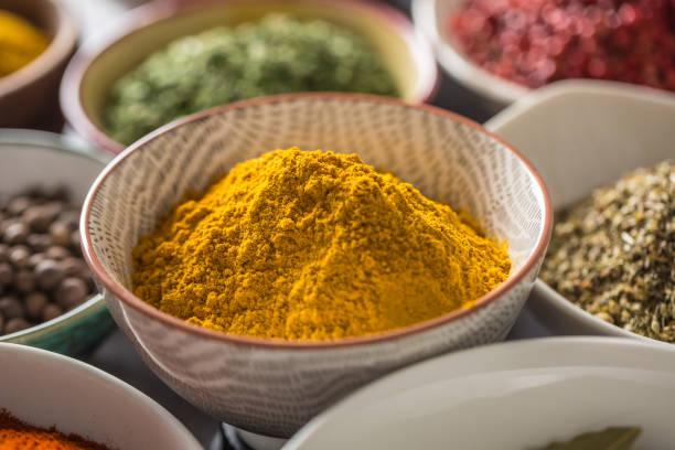 istock Curry and variety spices and herbs in bowls 1198845729