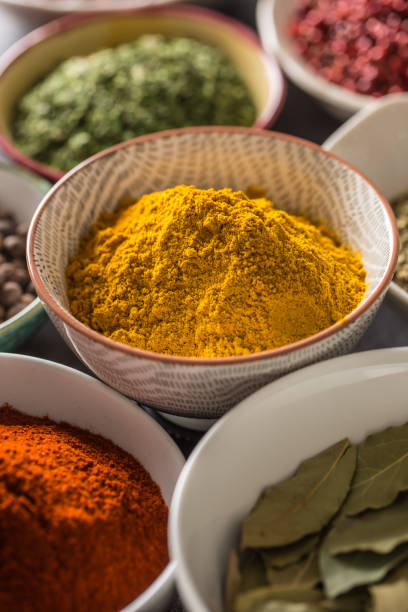 istock Curry and variety spices and herbs in bowls 1198845744