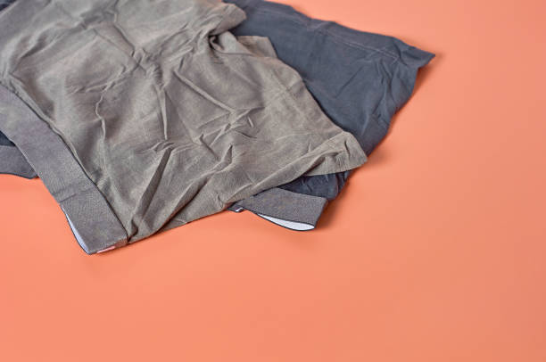 istock Two dark new male underpants, boxers on orange background. Space for text 1198845854