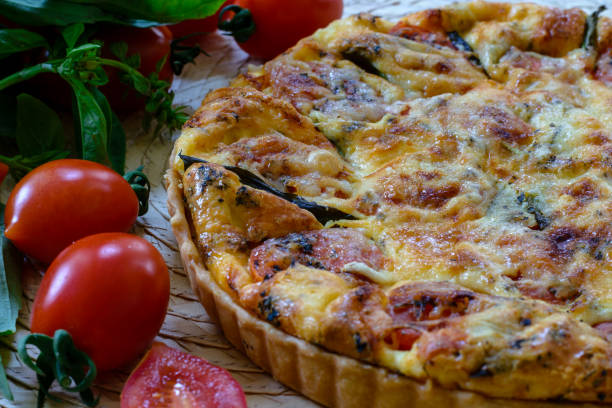 istock French pie . Quiche lorraine with tomatoes cherry, basil and cheese 1198848499