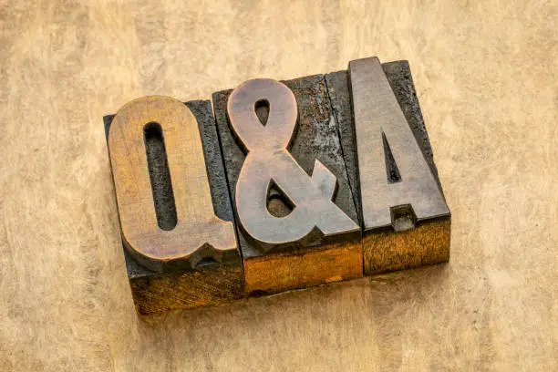 Questions and answers acronym - word abstract in vintage letterpress wood type printing blocks against handmade bark paper, communication and help concept