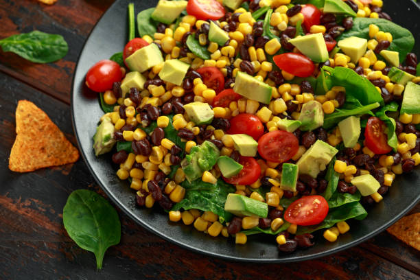 istock Mexican Salad with Avocado, Black Beans, sweet corn, spinach, tomatoes and Tortilla chips 1198849955
