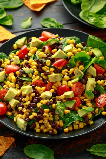istock Mexican Salad with Avocado, Black Beans, sweet corn, spinach, tomatoes and Tortilla chips 1198850006