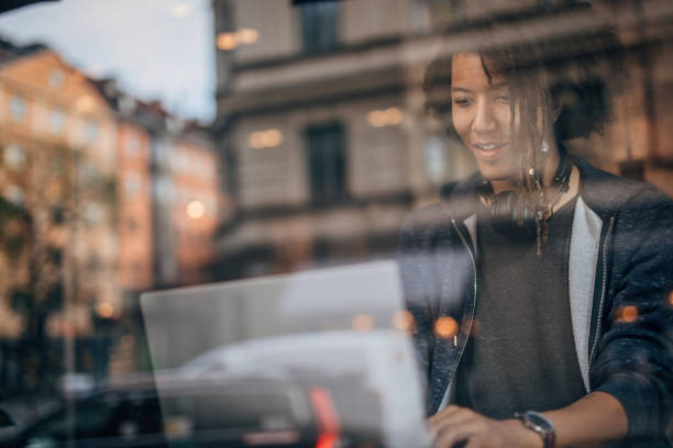 istock Man working on laptop in coffee shop 1198851508