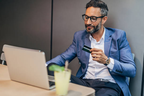 istock Man with credit card in cafe 1198852613