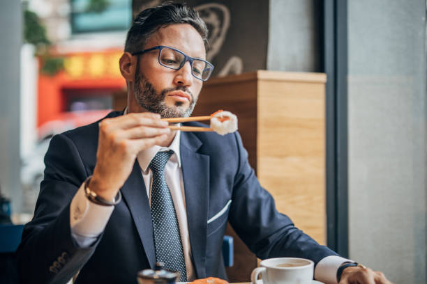 istock Man eating sushi in the restaurant 1198852885