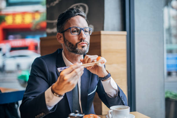 istock Man eating sushi in the restaurant 1198852902