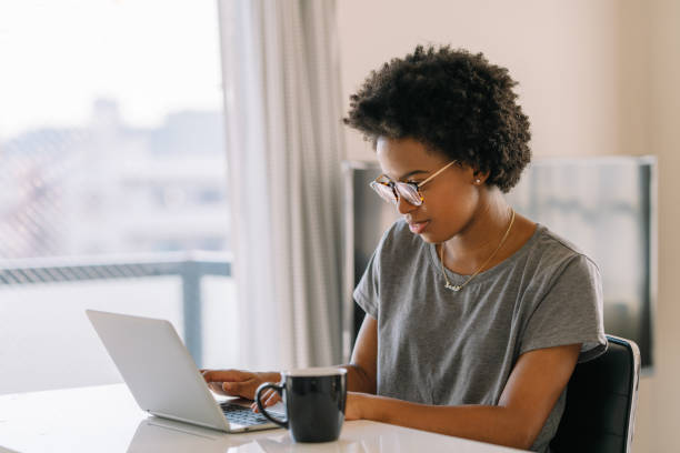 istock Young black beautiful woman using laptop at home 1198852951