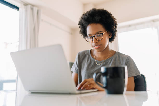 istock Young black beautiful woman using laptop at home 1198853031