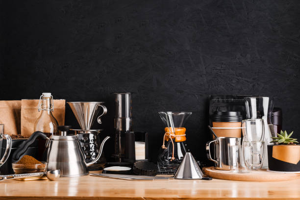 istock Accessories and utensils for making coffee drinks on a wooden table, coffee shop interior 1198856120