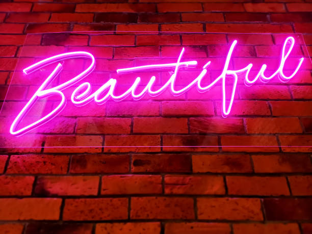 istock Pink Illuminated Glowing Beautiful Text on Brick Wall 1198857760