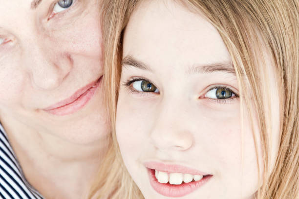 istock Beautiful mother and daughter on white 1198859742