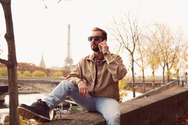 istock Handsome man enjoying in Paris while using cellphone. 1198860097