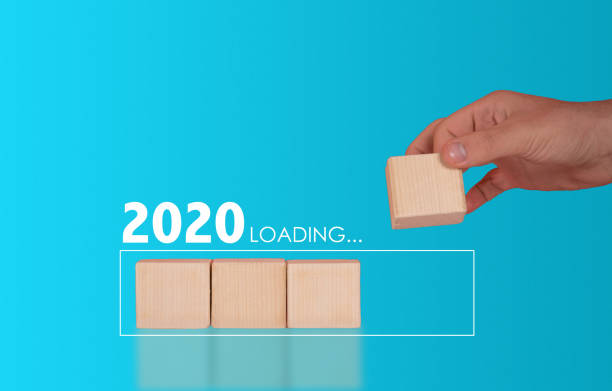 istock 2020 loading concept. man placing wooden cubes 1198860409