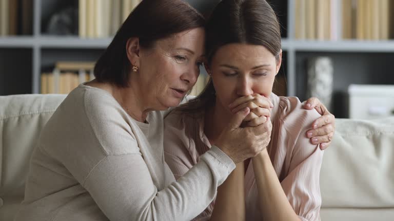 Older mature mom embrace console apologize upset young adult daughter