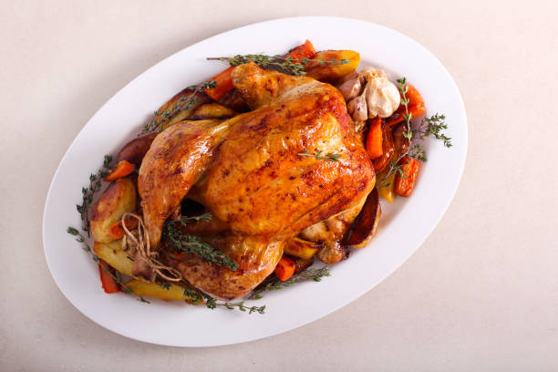 istock Roast whole chicken with roast vegetables 1198864152
