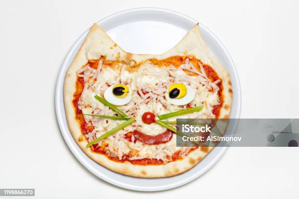 Childrens Pizza In The Shape Of A Cats Face On A White Plate Stock Photo - Download Image Now