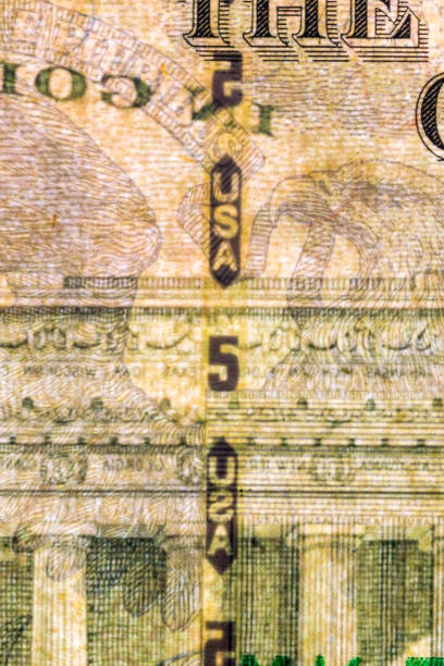 istock Plastic security strip inside 5 USD banknote. Security strip on American banknote created to prevent counterfeiters. 1198867678