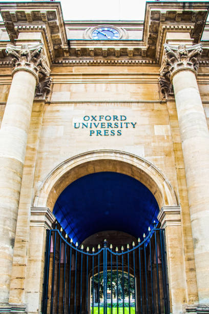 View of an entrance to Oxford University Press with pillars and and a courtyard seen through an iron gate 7-27-2019 Oxford UK View of an entrance to Oxford University Press with pillars and and a courtyard seen through an iron gate oxford university photos stock pictures, royalty-free photos & images